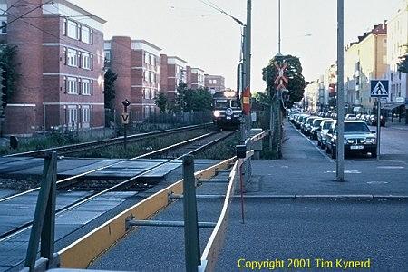 Sundbyberg, RR crossing, southbound train approaching