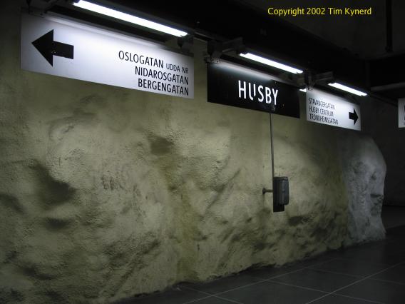 Husby, station name and direction signs